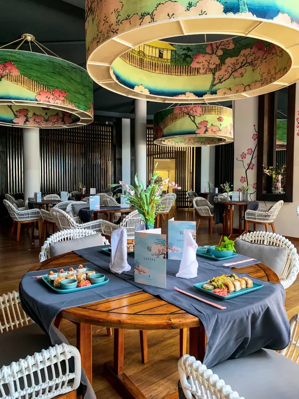Japanese restaurant interior with painted lantern shades and sushi table at Le Sultan — Aziz Stiti
