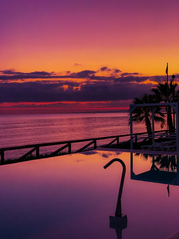 Vivid purple and orange sunset over infinity pool at TUI Blue Palm Beach — Aziz Stiti