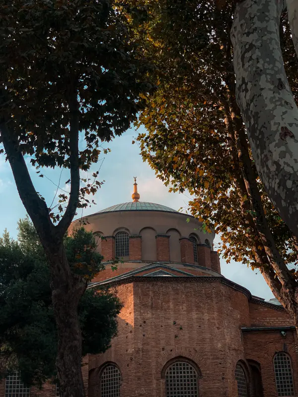 Historic Byzantine church dome framed by autumn trees in Istanbul — Aziz Stiti travel photography