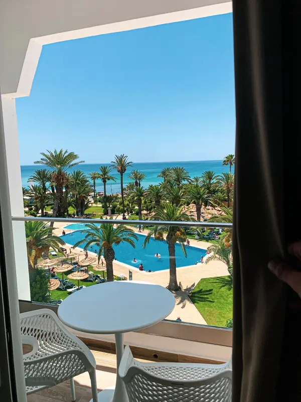 Balcony sea view overlooking palm trees and pool at TUI Blue Palm Beach — Aziz Stiti